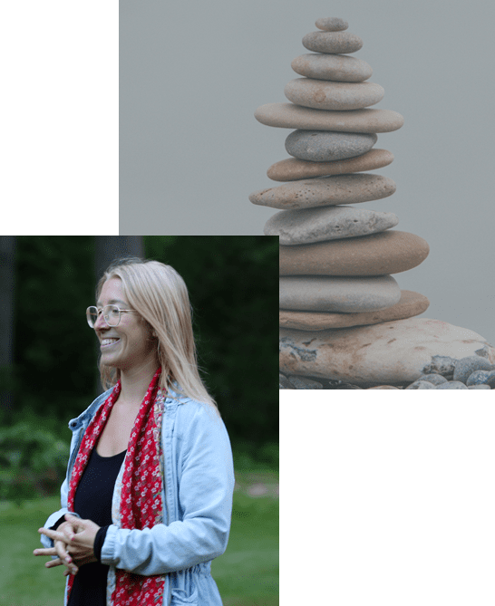 A woman standing next to a pile of rocks.